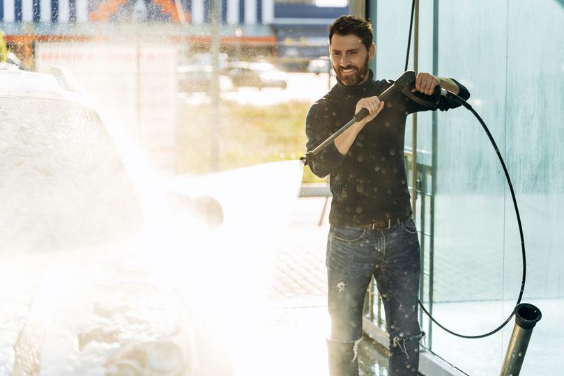 A pressure washing professional cleaning a driveway