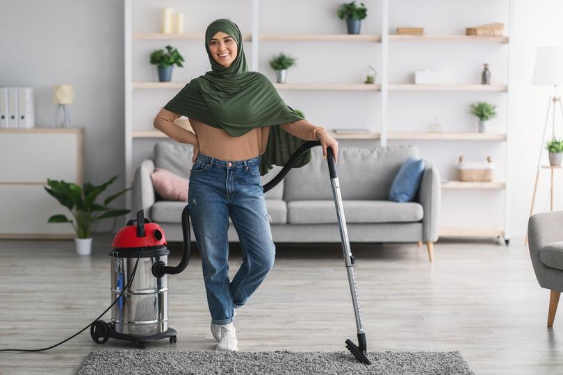 A carpet cleaning professional cleaning a carpet in a home